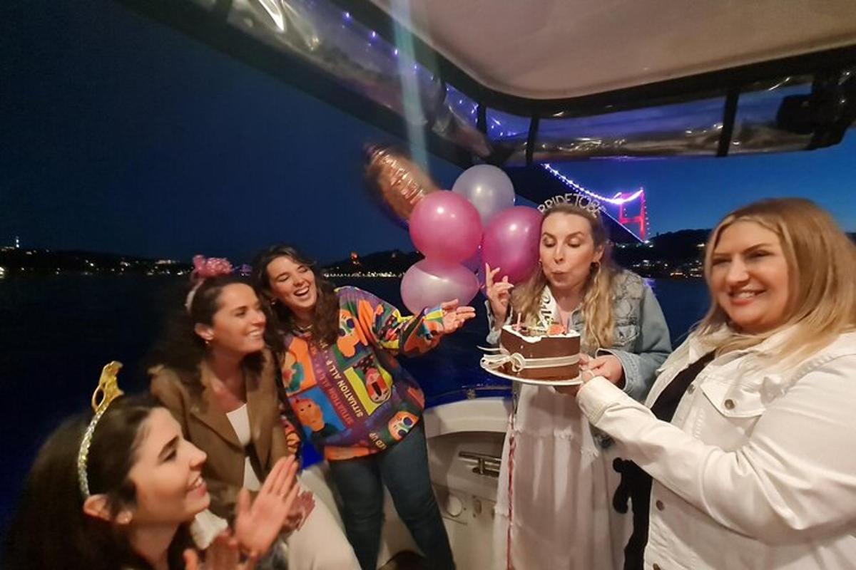a group of women standing on a boat with a cake
