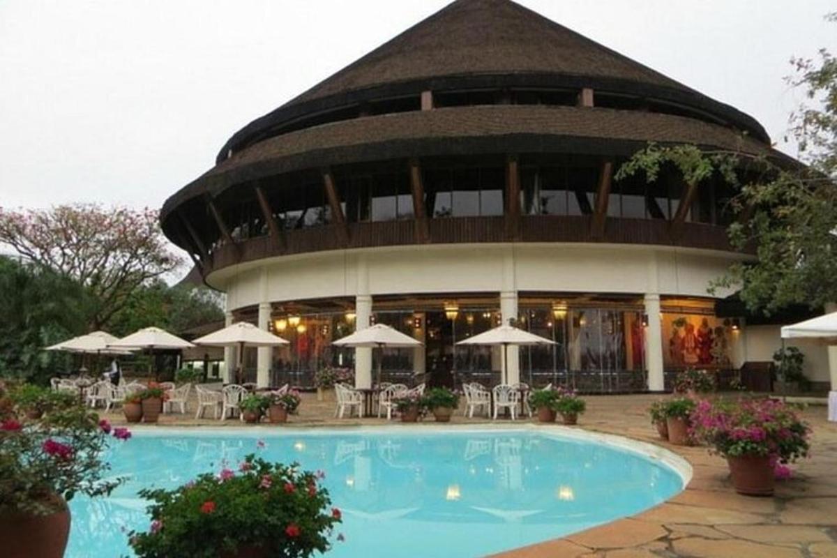 un gran edifici amb una piscina al davant