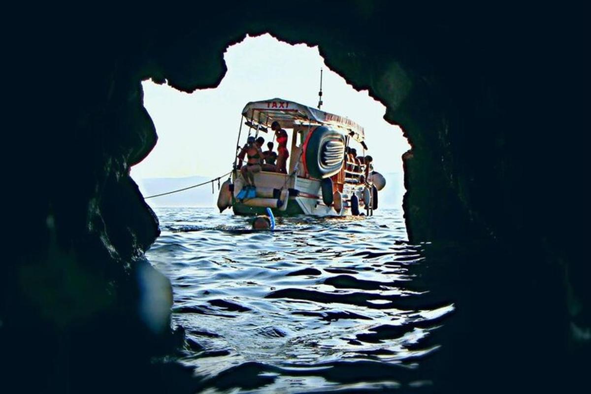 a boat in the water through a cave
