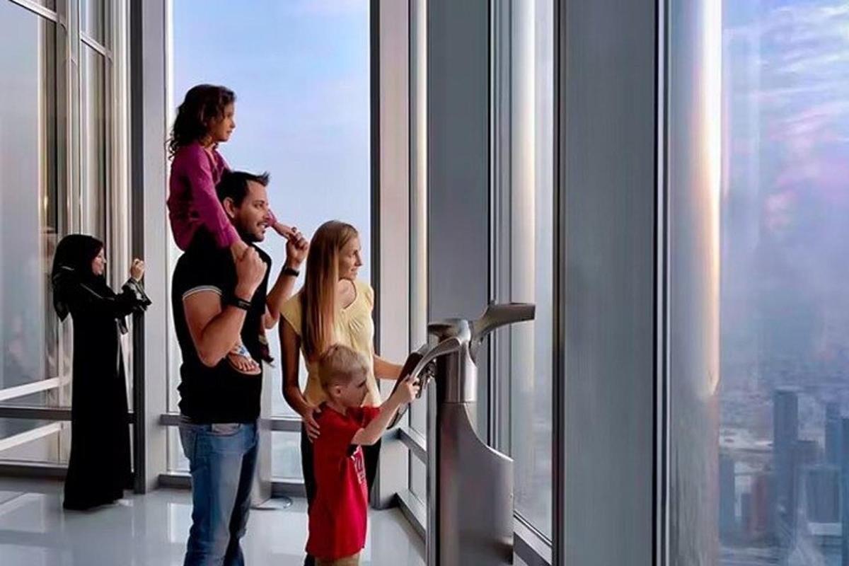 a family standing in front of a window in a skyscraper