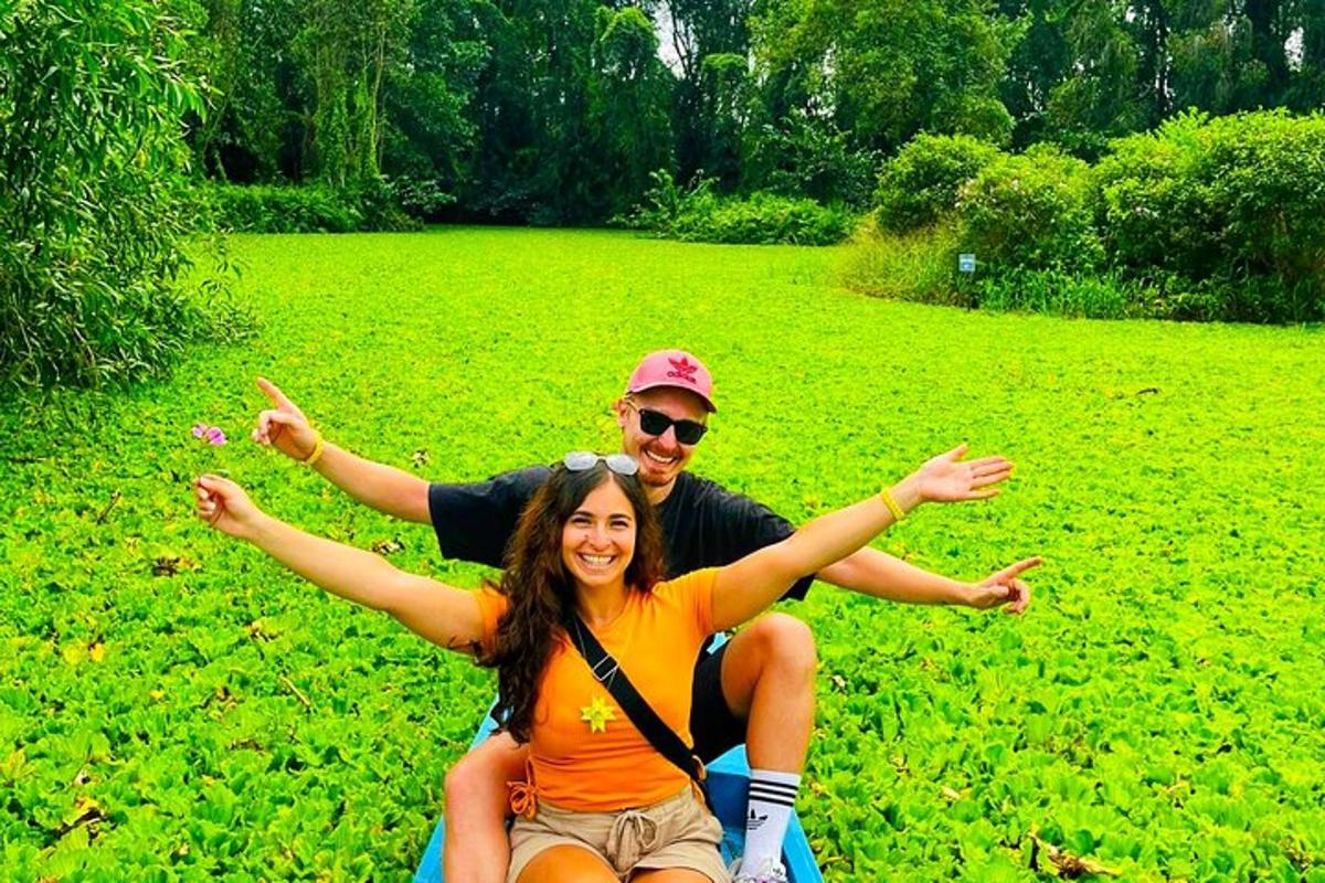 a man and a woman sitting on a motorcycle in a field
