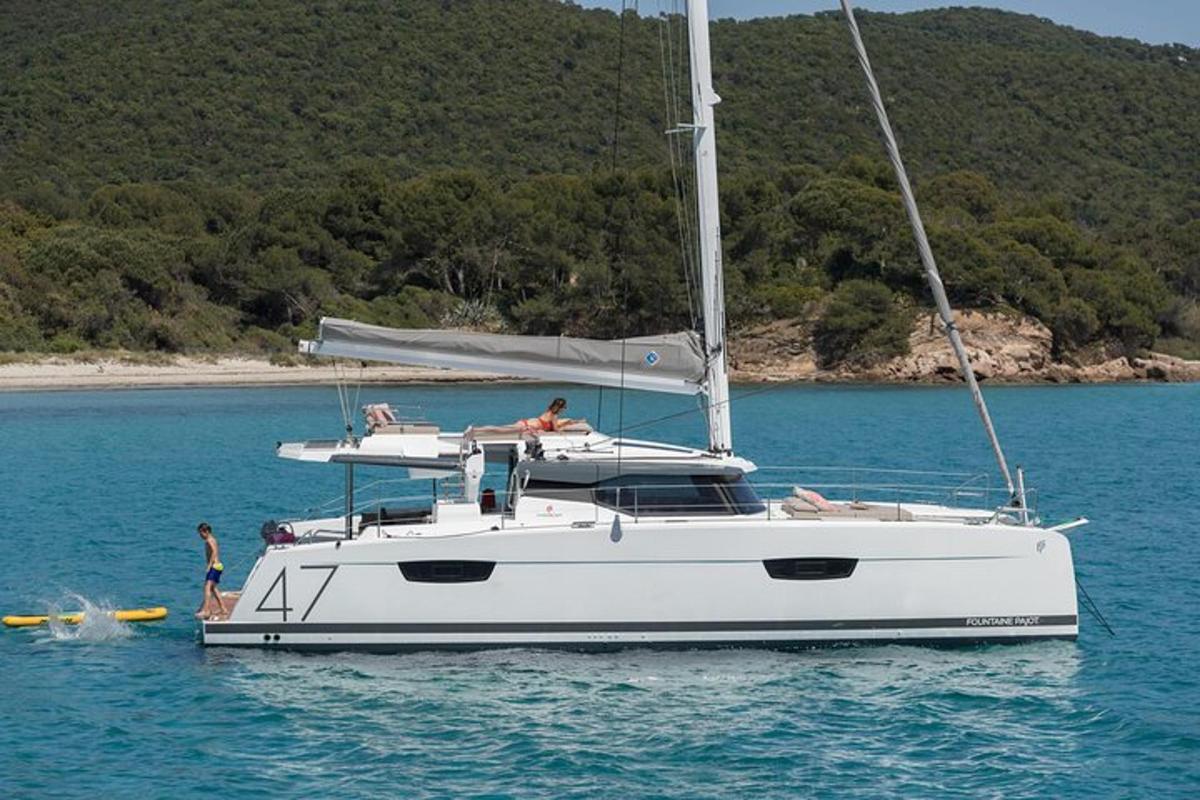 a white boat in the water with people on it