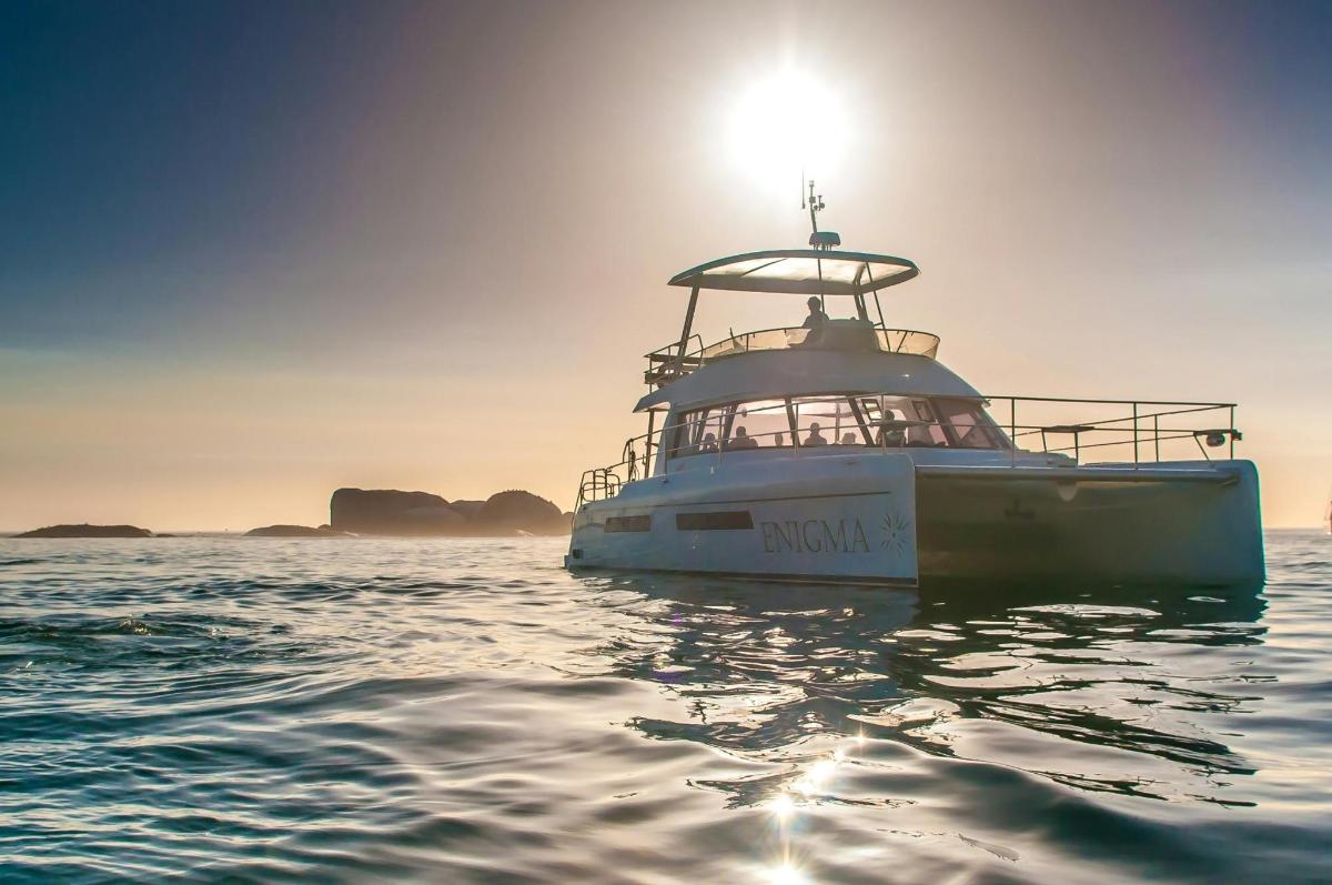Un barco flotando en el agua con la puesta del sol