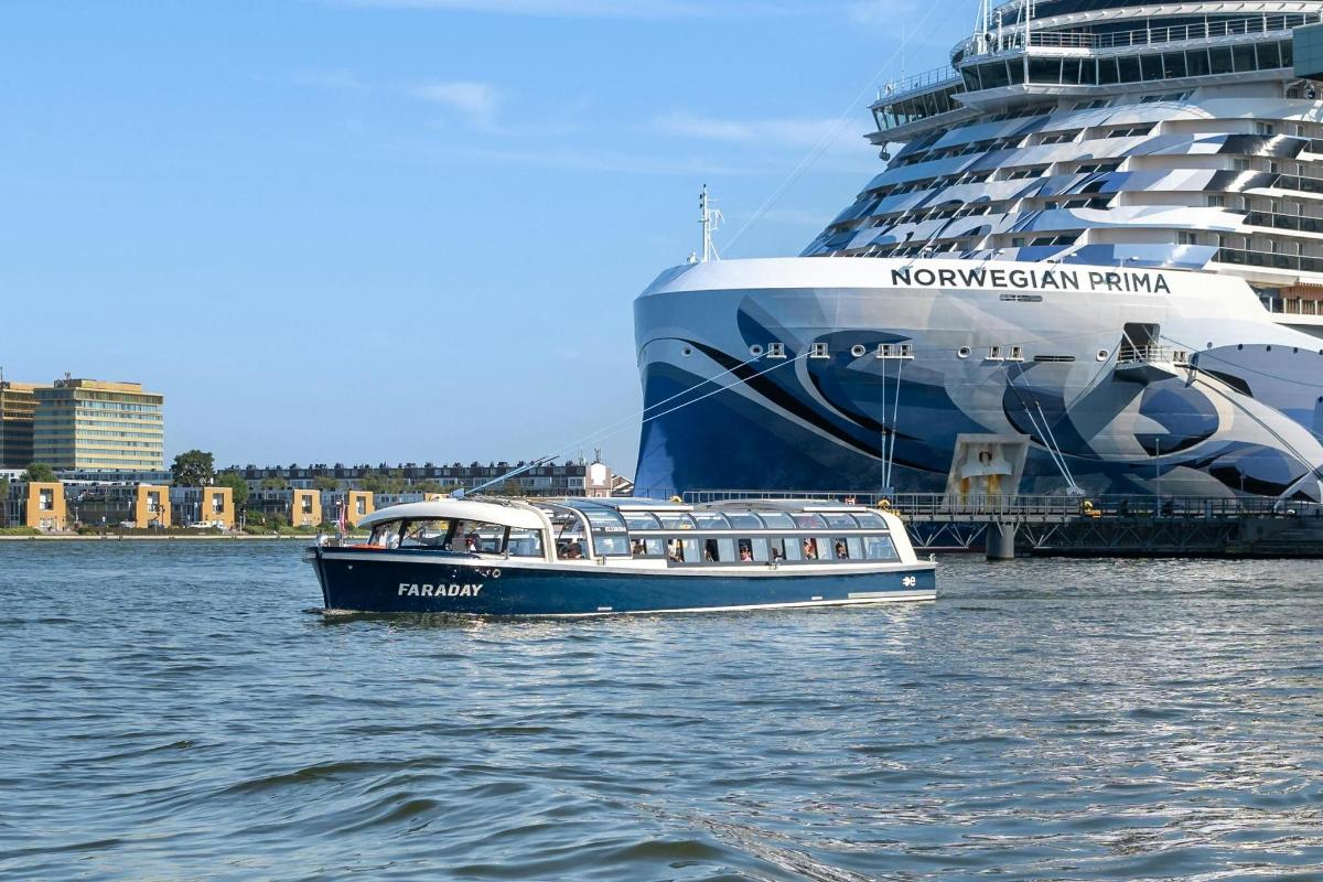 una barca in acqua accanto a una nave da crociera