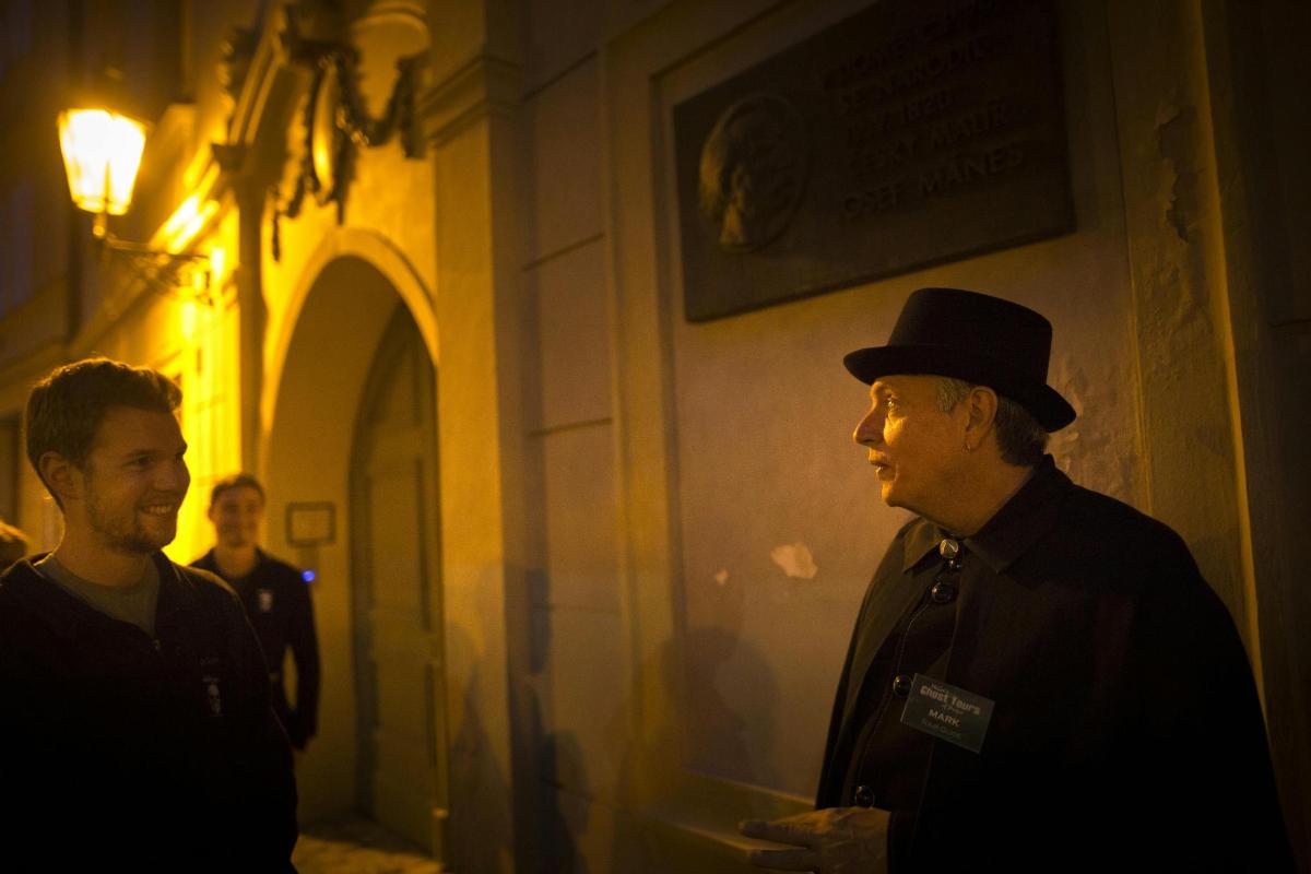 two men are standing in a dark room