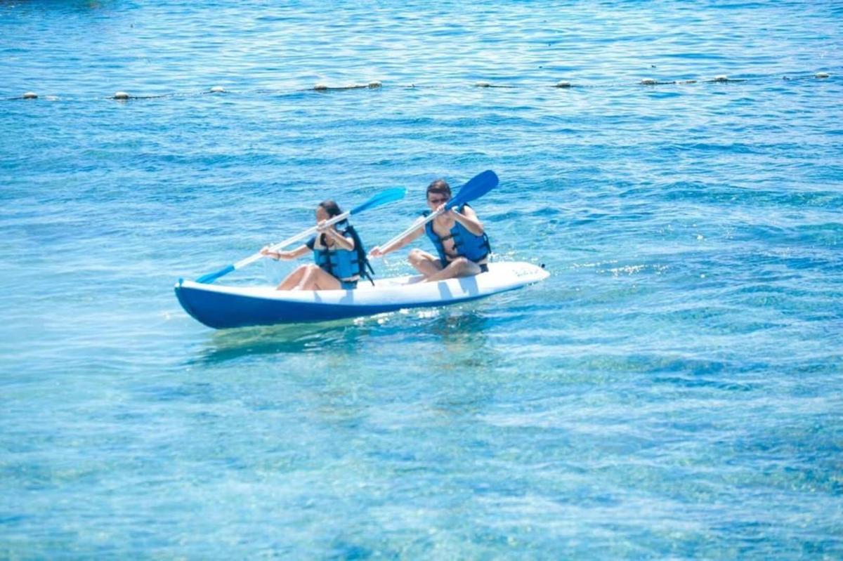 two women in a paddle boat in the water