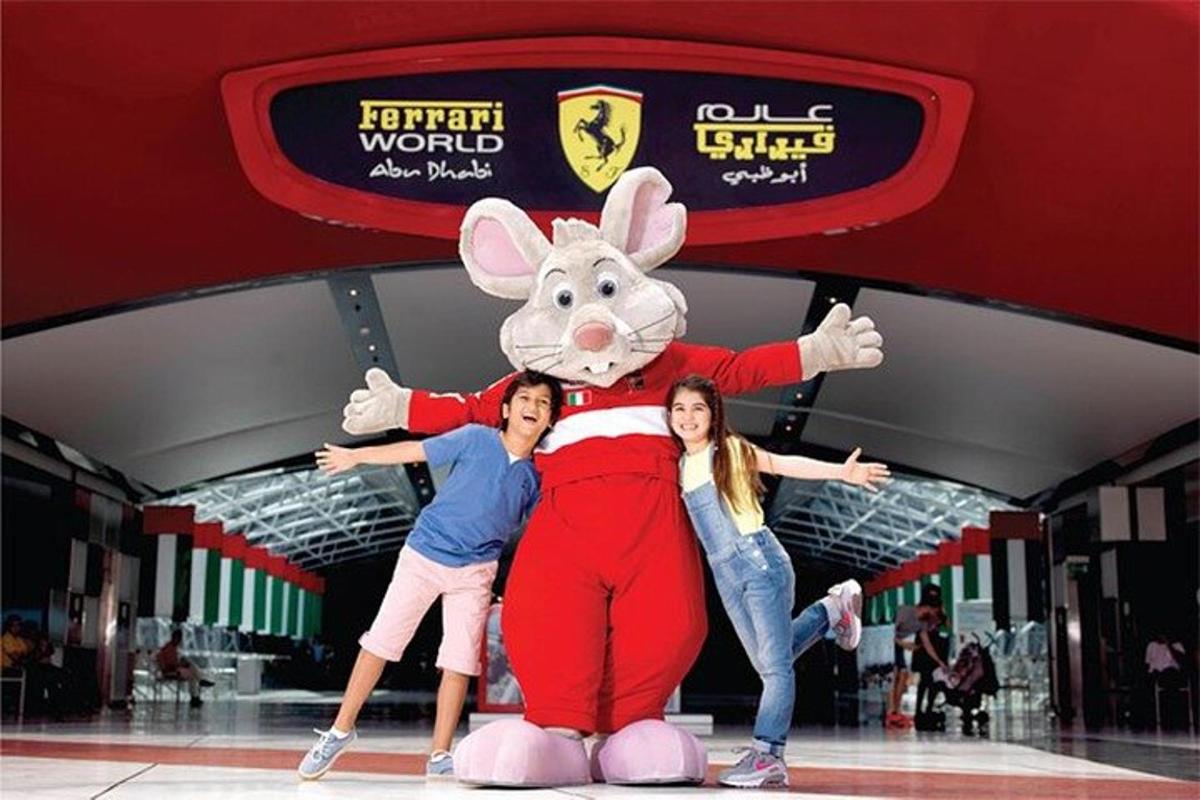 two girls posing with a mickey mouse costume in a mall