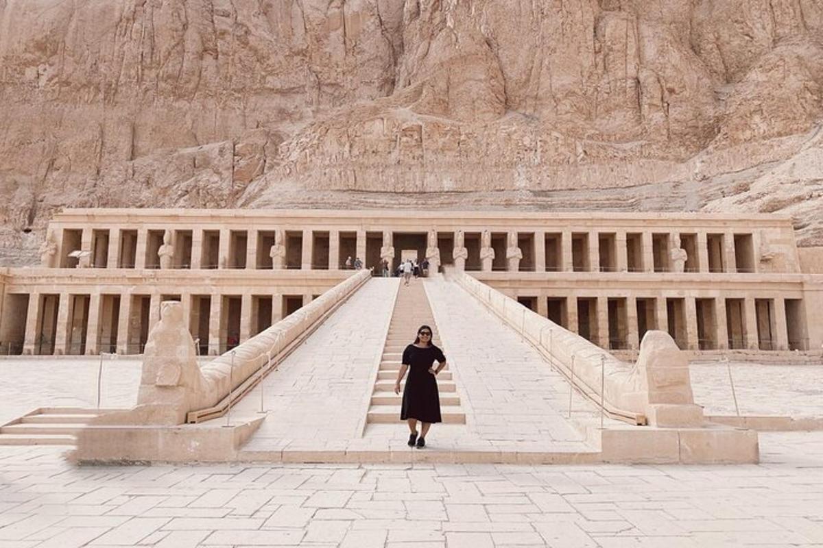 a woman standing on a staircase in front of a building