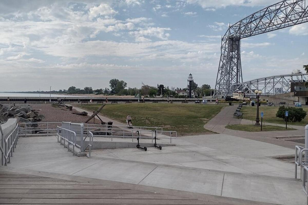 a park with a roller coaster and a bridge