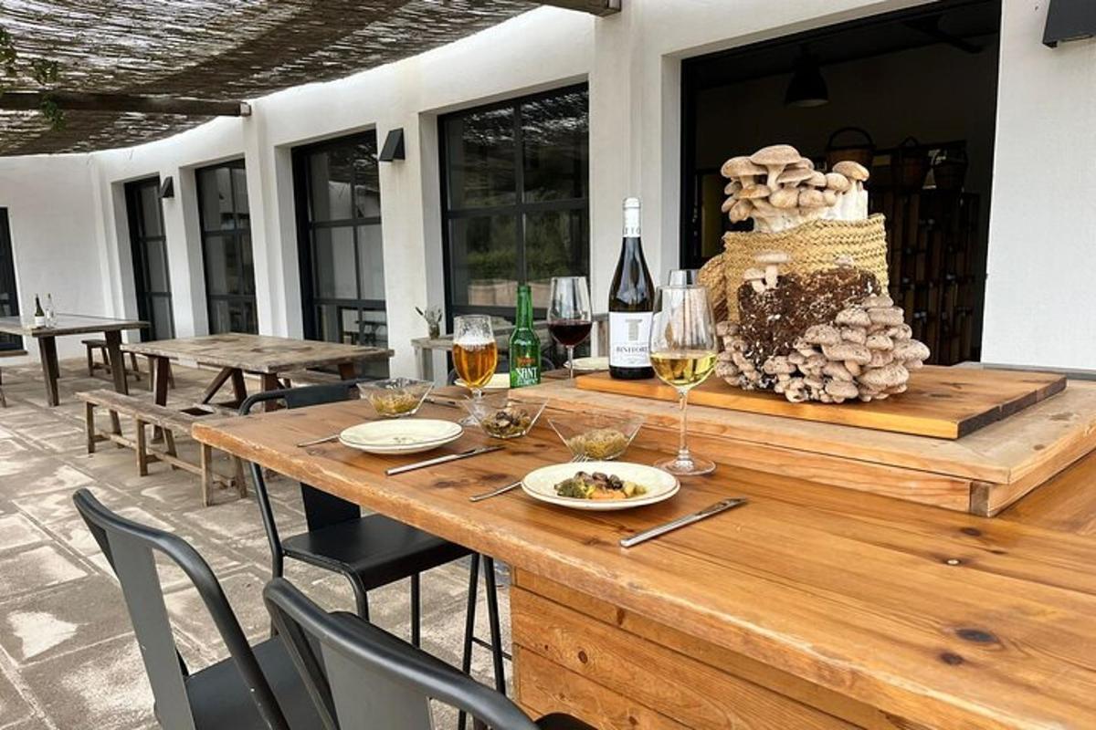 a wooden table with glasses of wine on a patio