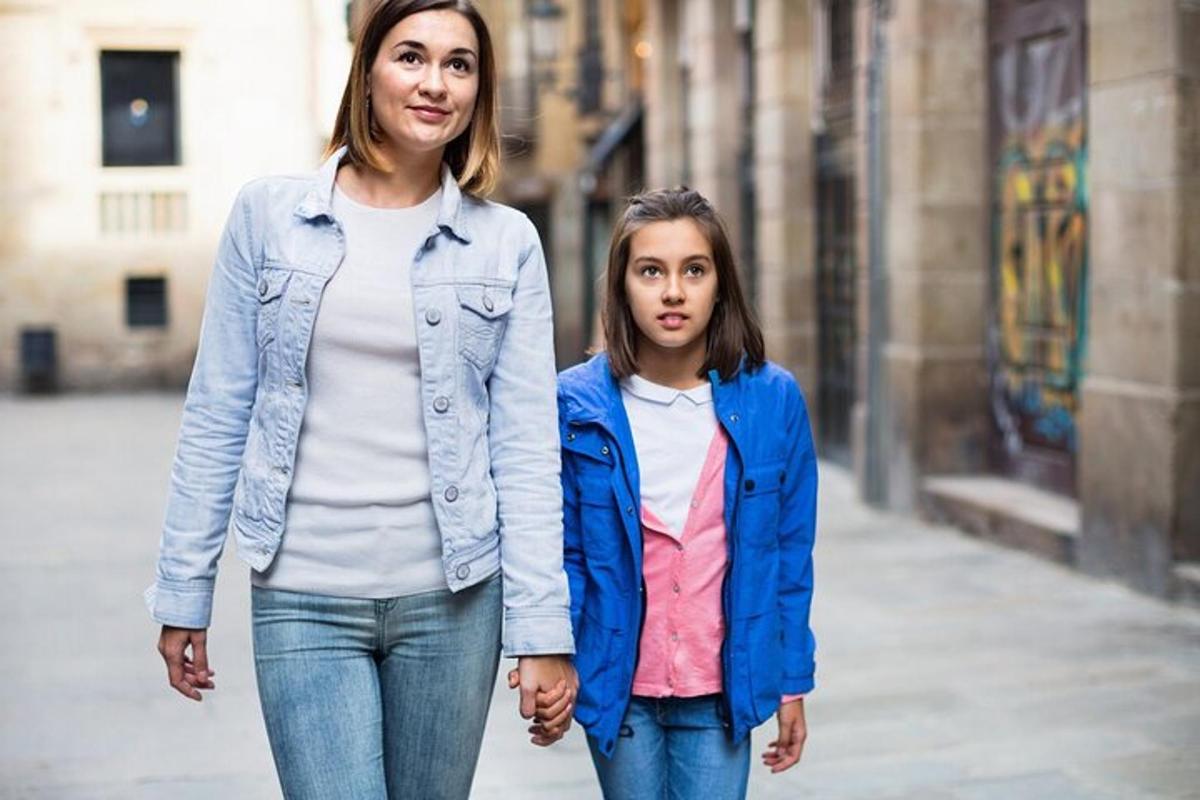 una donna e una bambina che camminano lungo una strada