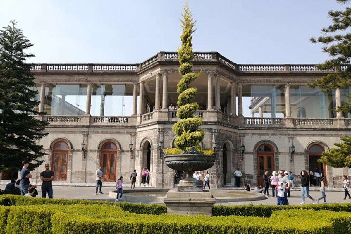 a large building with a fountain in front of it