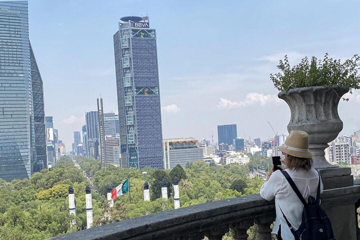 a woman taking a picture of a city skyline