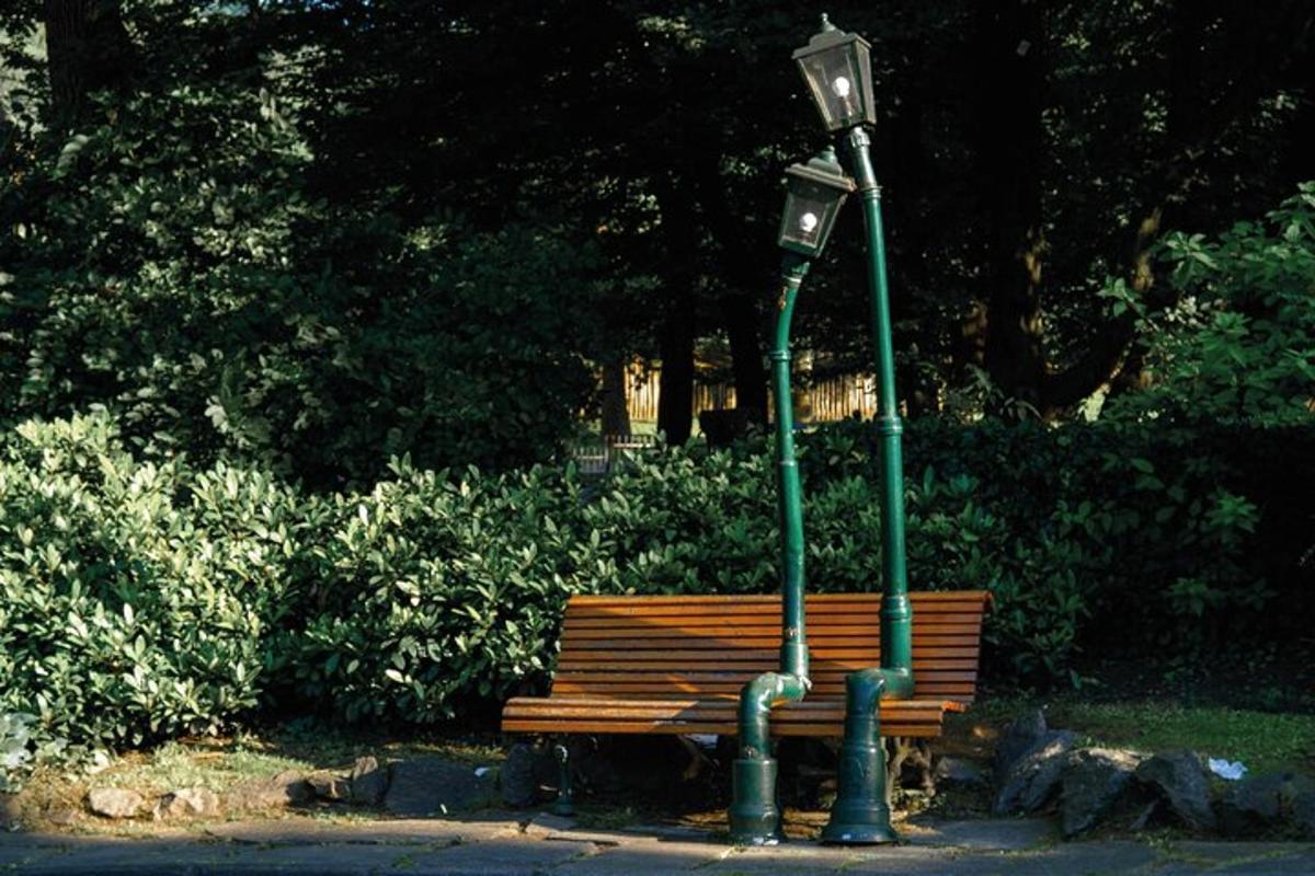 a park bench next to a light pole