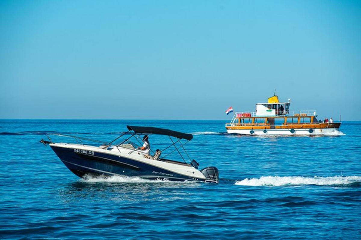 a boat in the water with two other boats