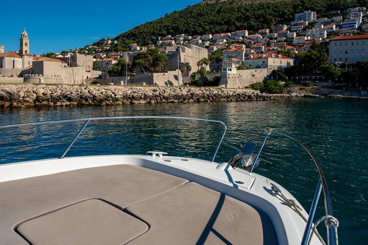 a boat in a body of water with a city