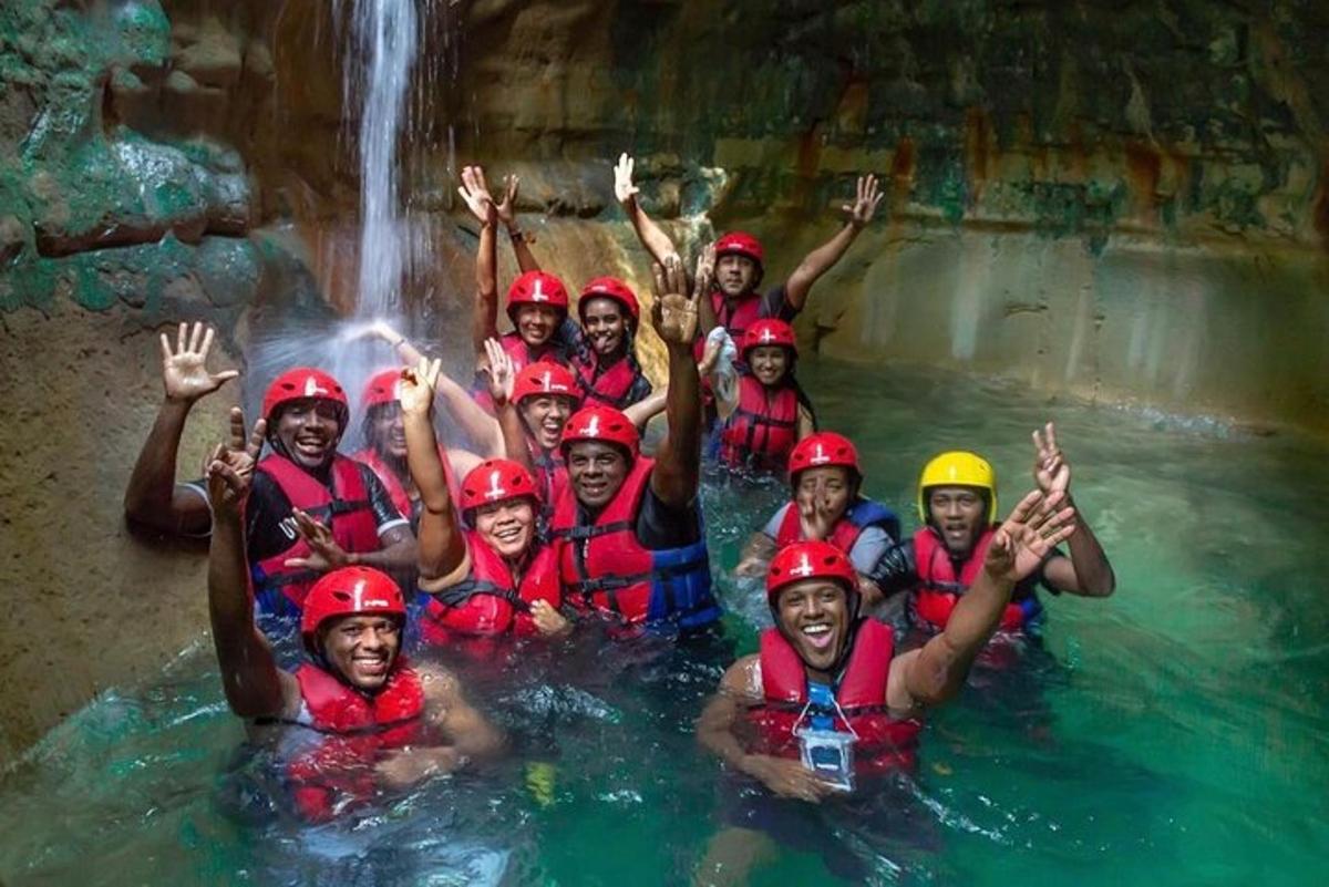 a group of people in a raft in a waterfall