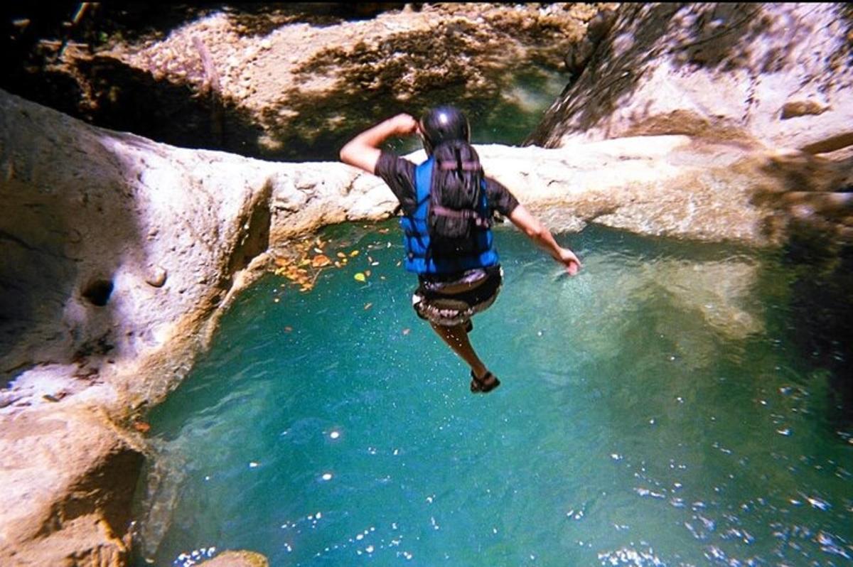 a person jumping into a body of water