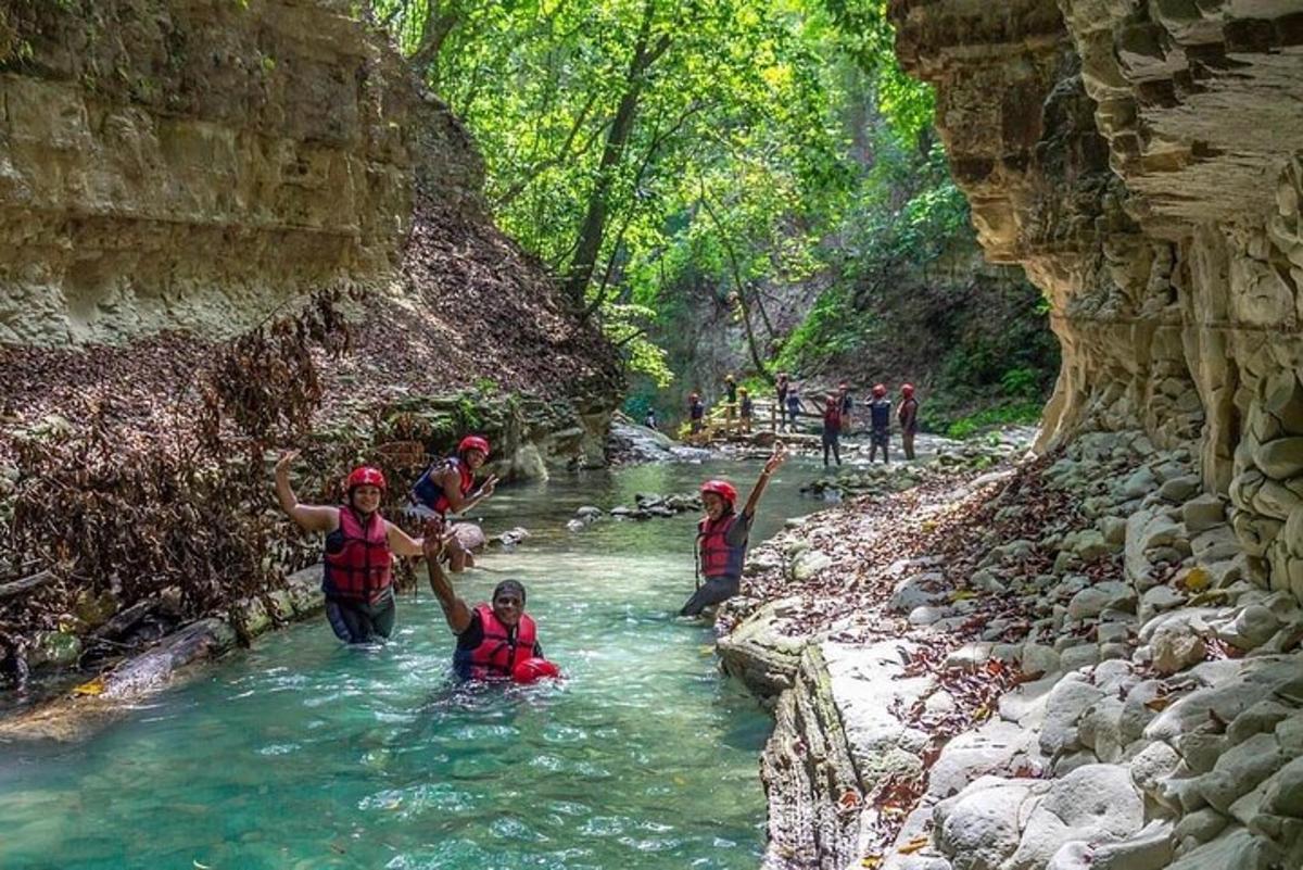 a group of people in the water in a river
