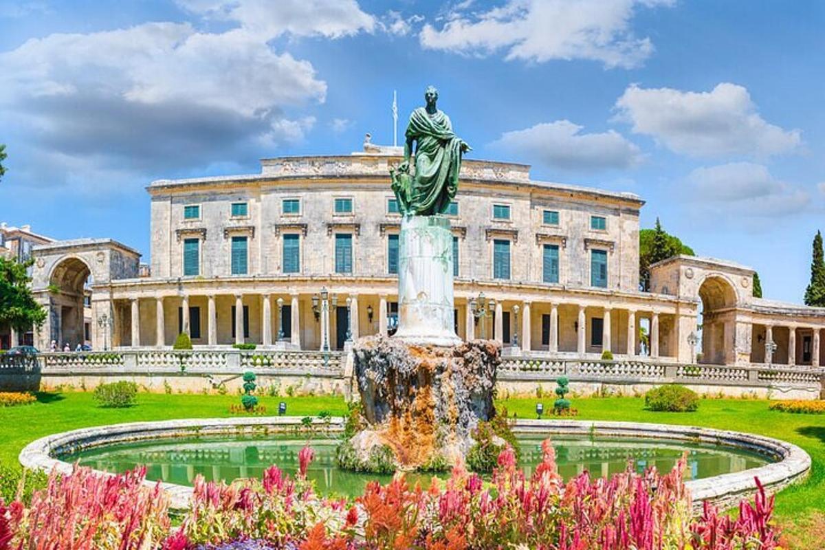 a statue in front of a building with a fountain