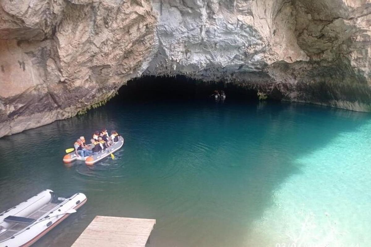 a group of people in a boat in a cave