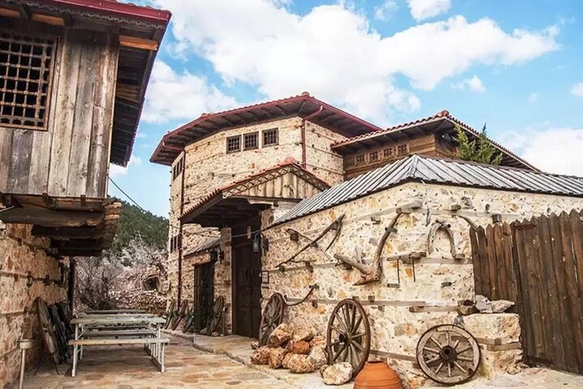 an old stone building with a bench in front of it