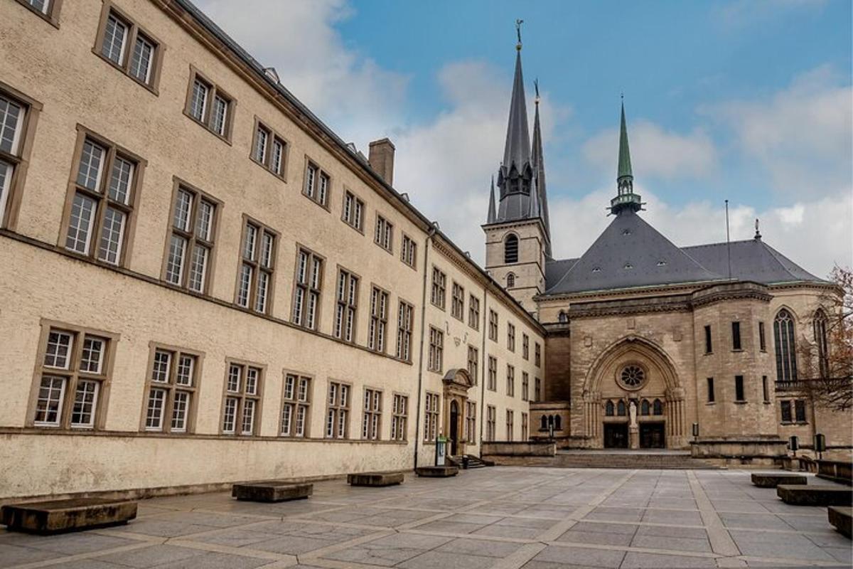 a large building with a church in the background