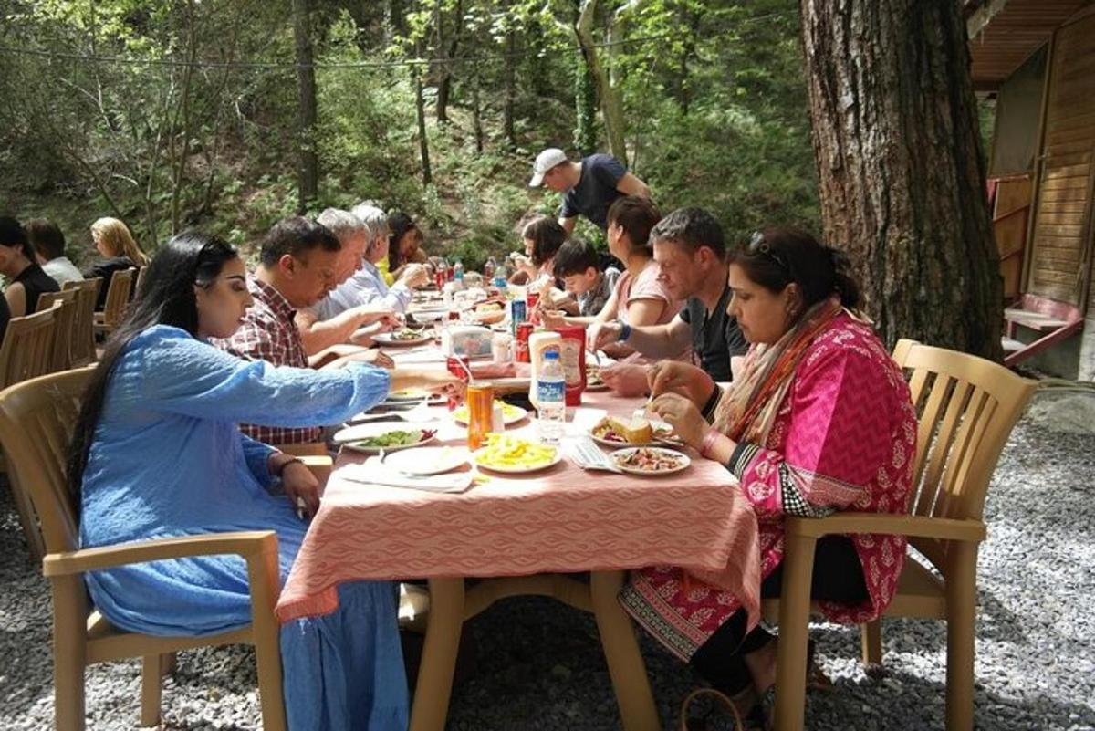 a group of people sitting at a table eating food