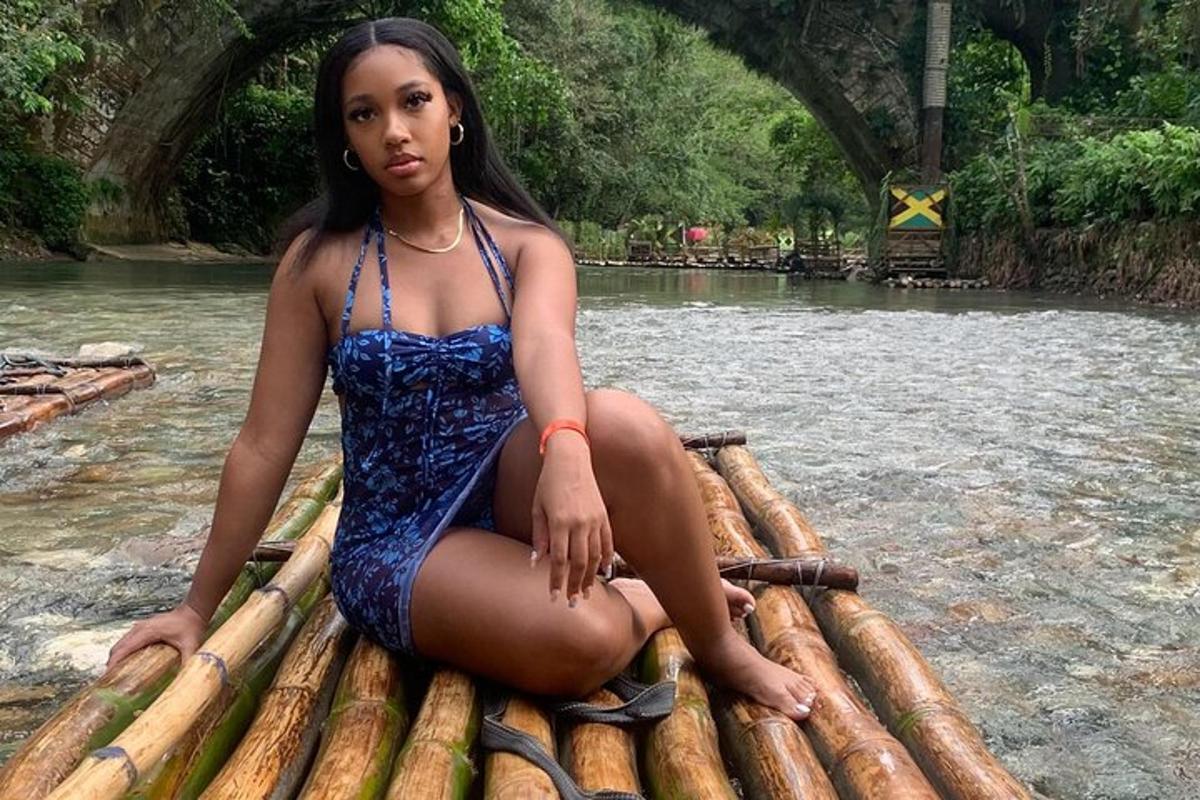 a woman sitting on a raft on a river