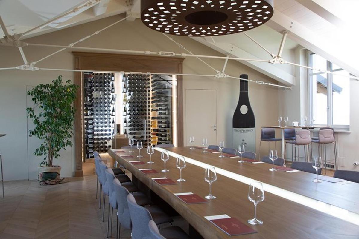 a long table in a room with chairs and wine bottles