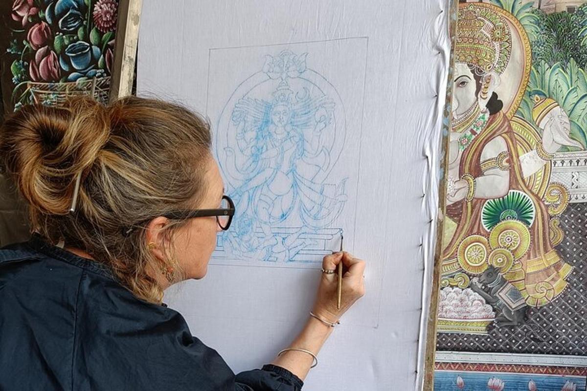 a woman is painting a picture on a wall