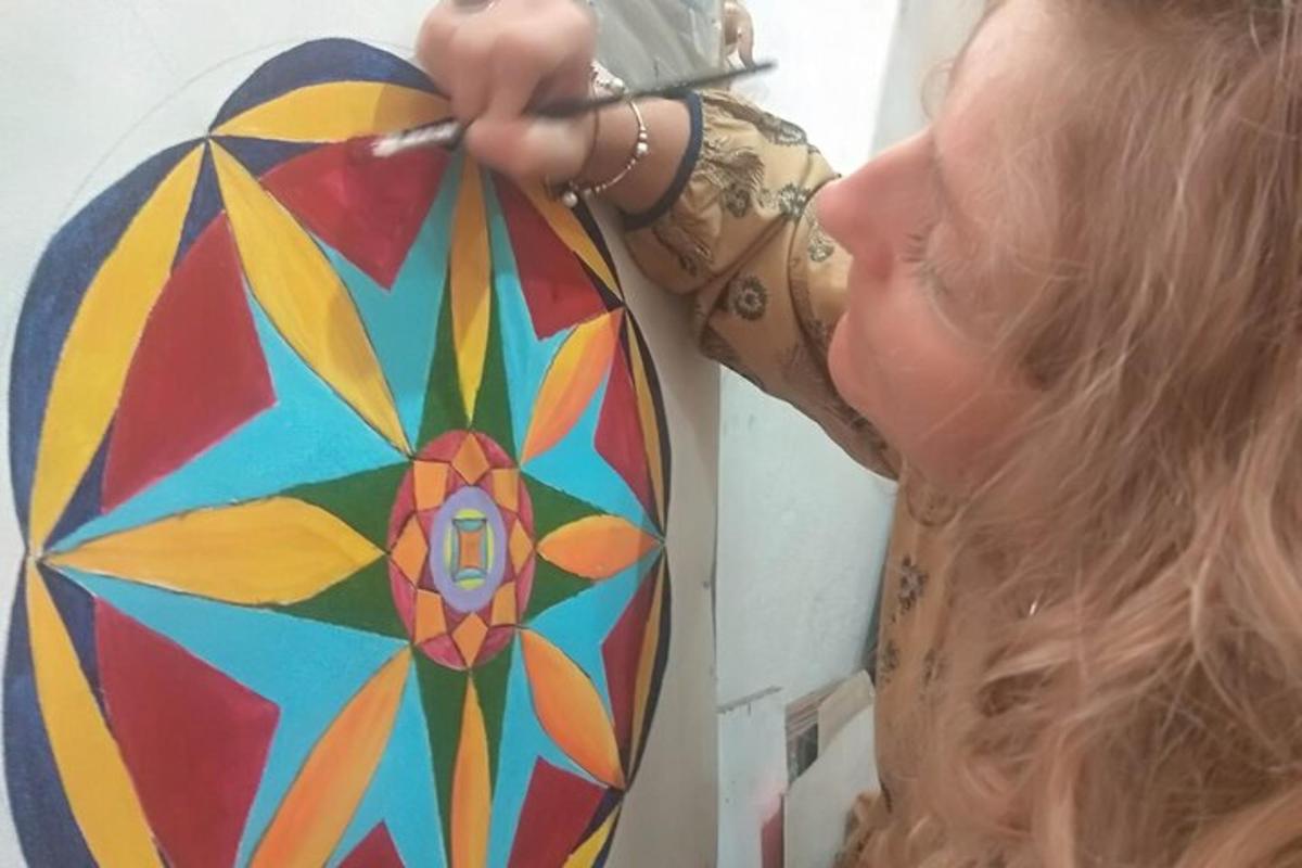 a woman is cutting a kite with a scissors