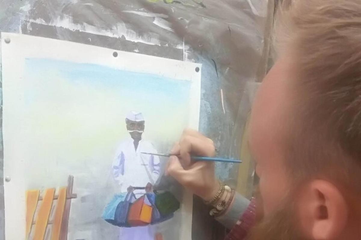 a young child painting a picture of a man