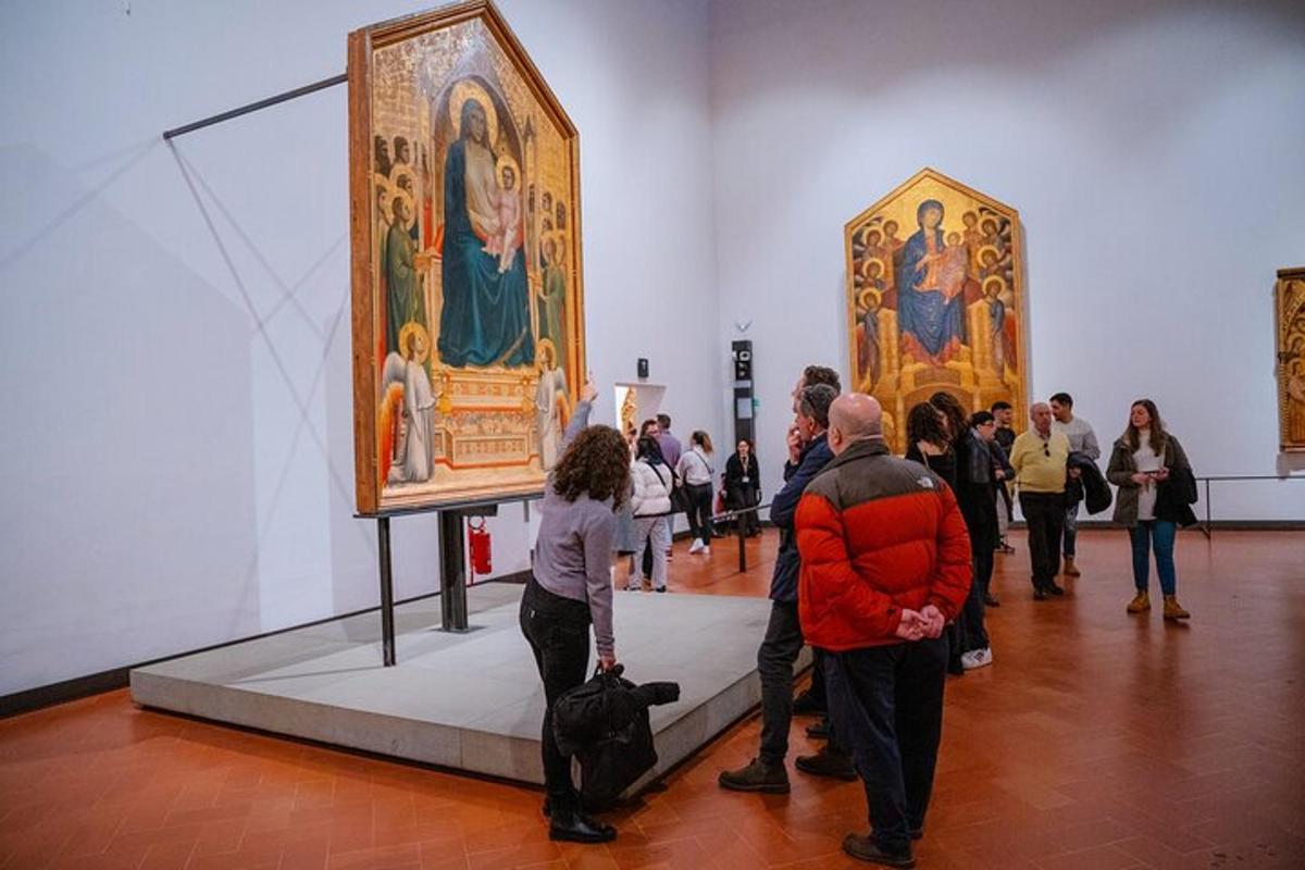 a group of people looking at paintings in a museum