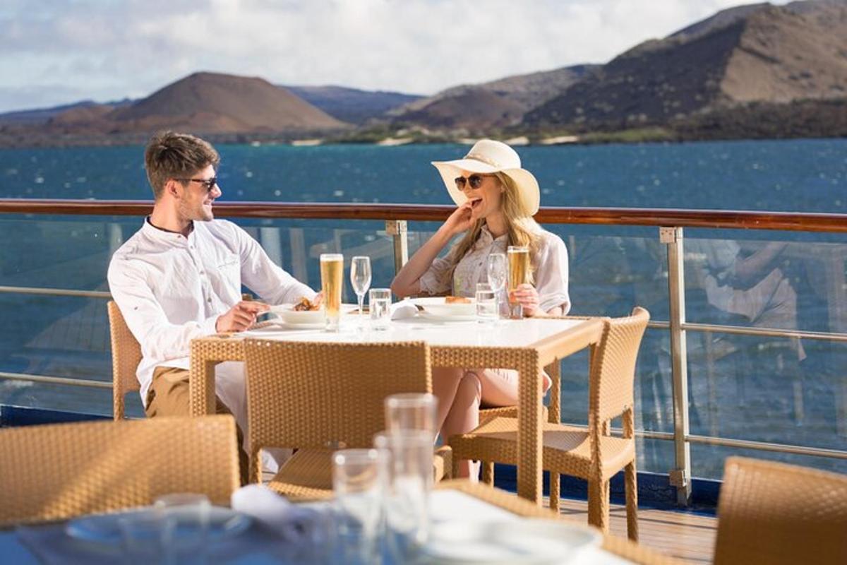 a man and woman sitting at a table on a ship