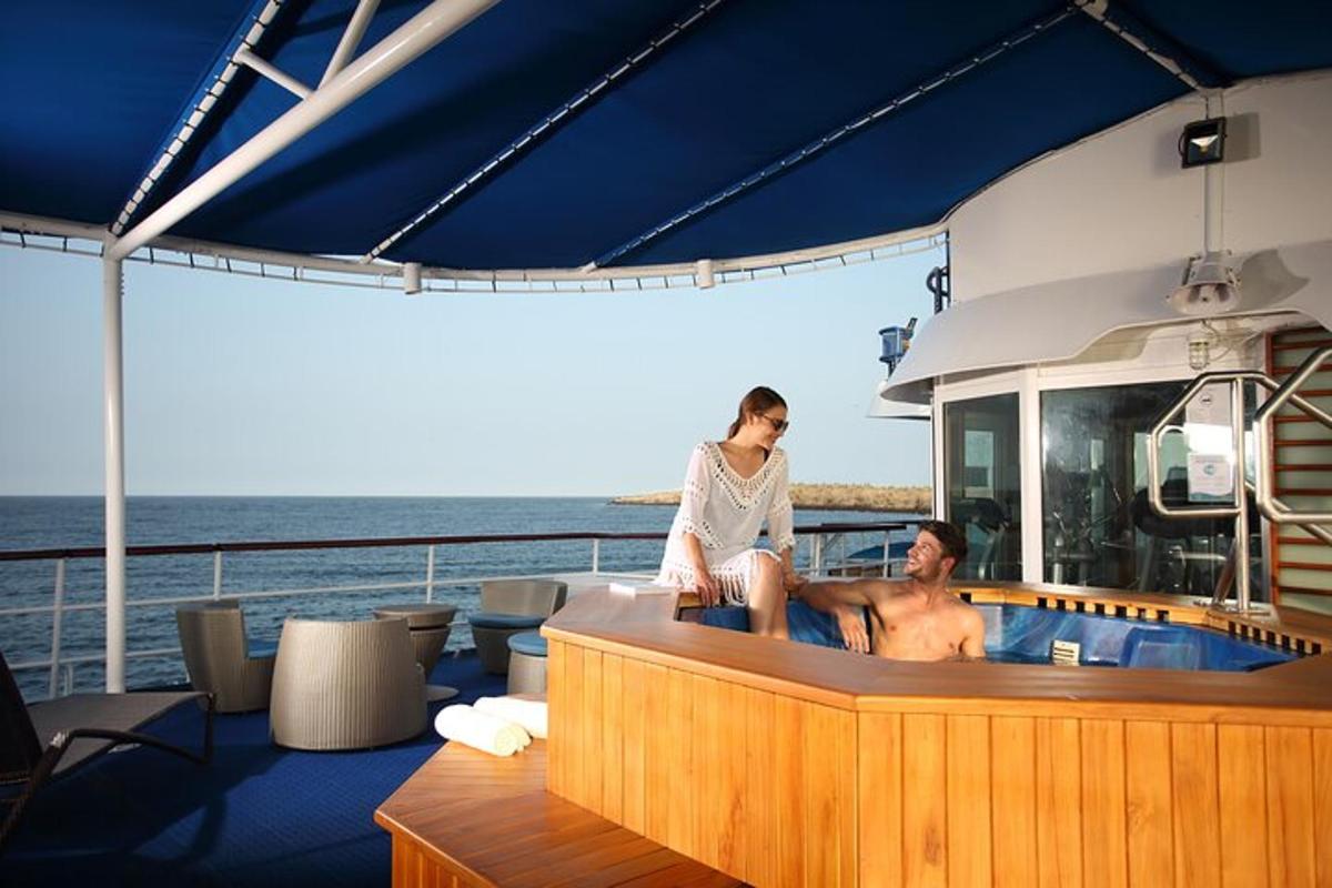 a woman sitting on the edge of a tub on a boat