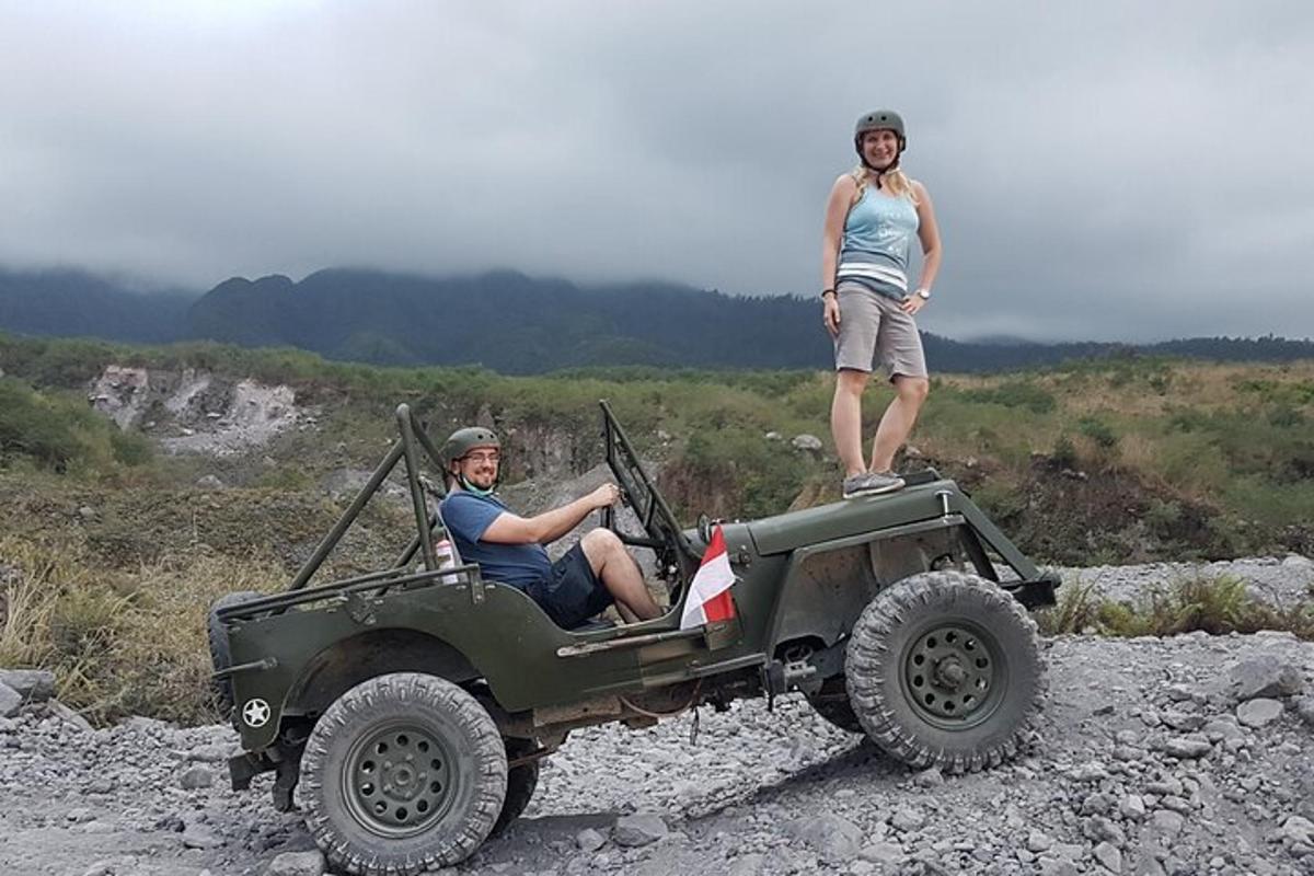 a man sitting in a jeep with a woman