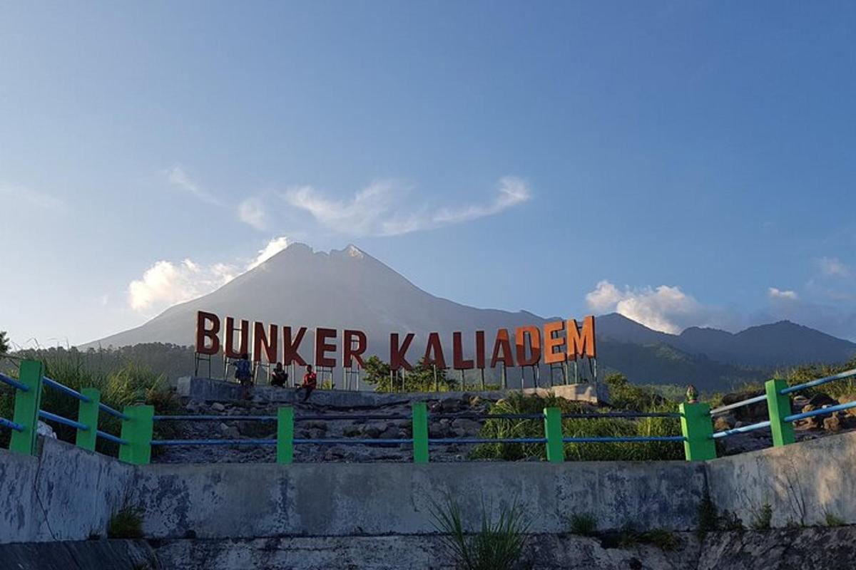 a building with a sign in front of a mountain