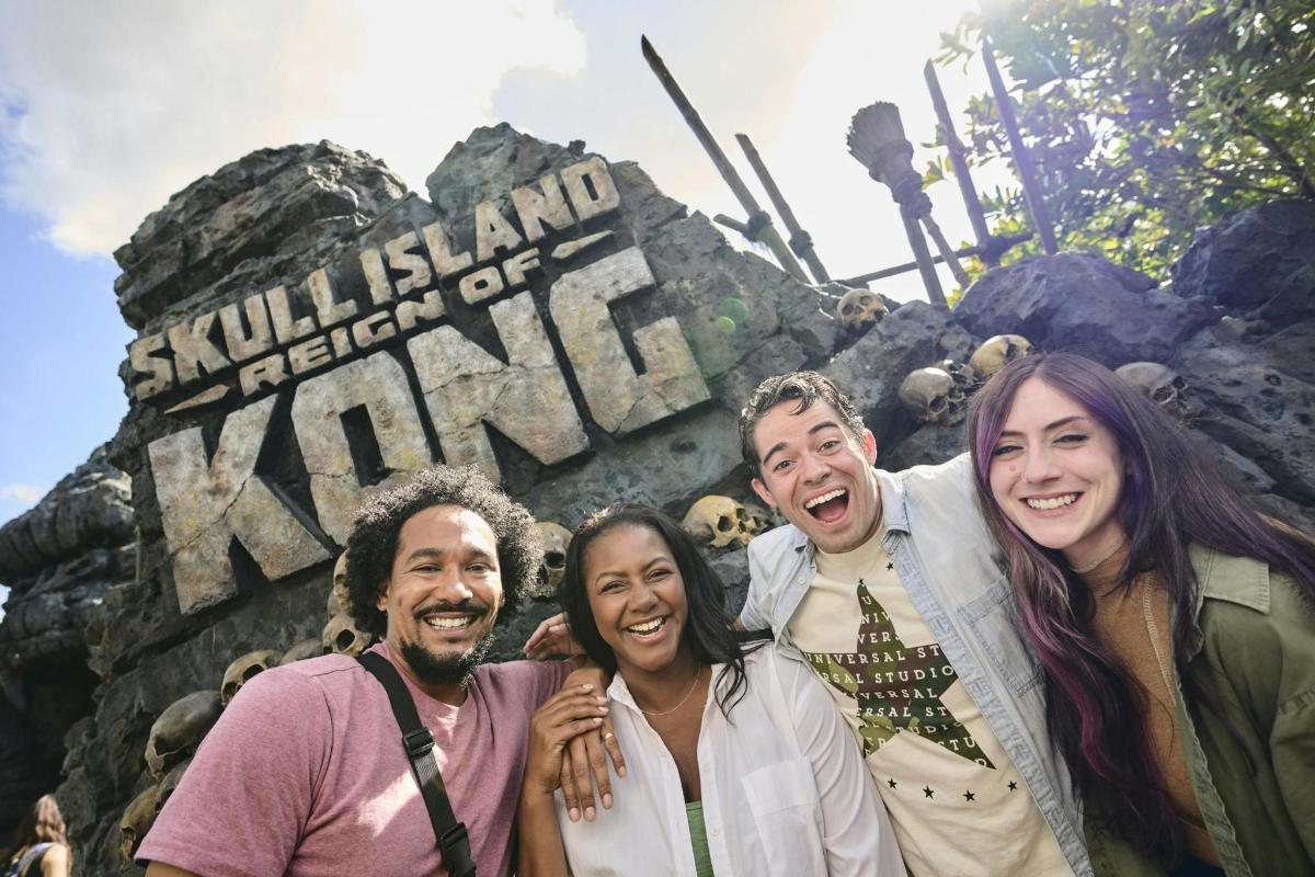 a group of people standing in front of a sign