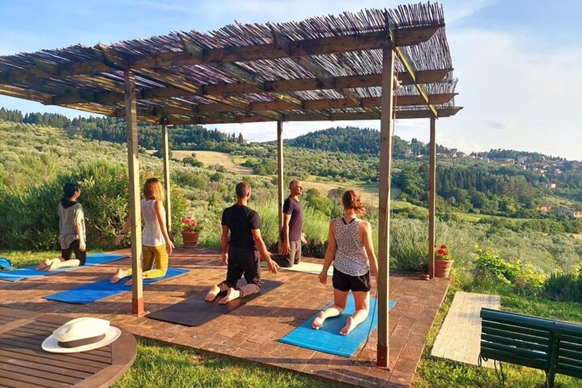 a group of people doing yoga under a pavilion