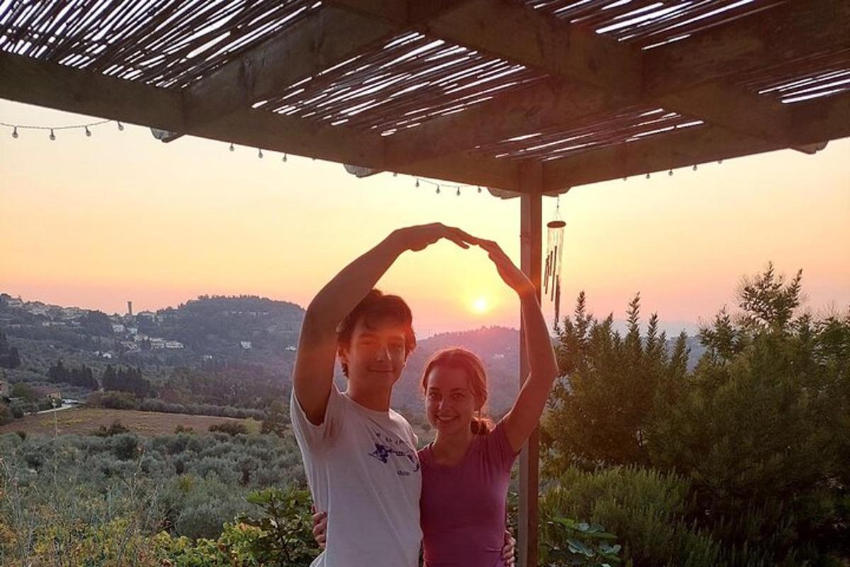 a man and a woman making a heart shape with their hands