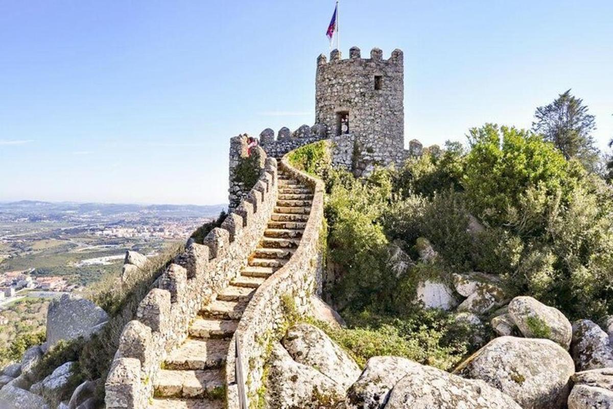 a castle on a hill with a stone wall