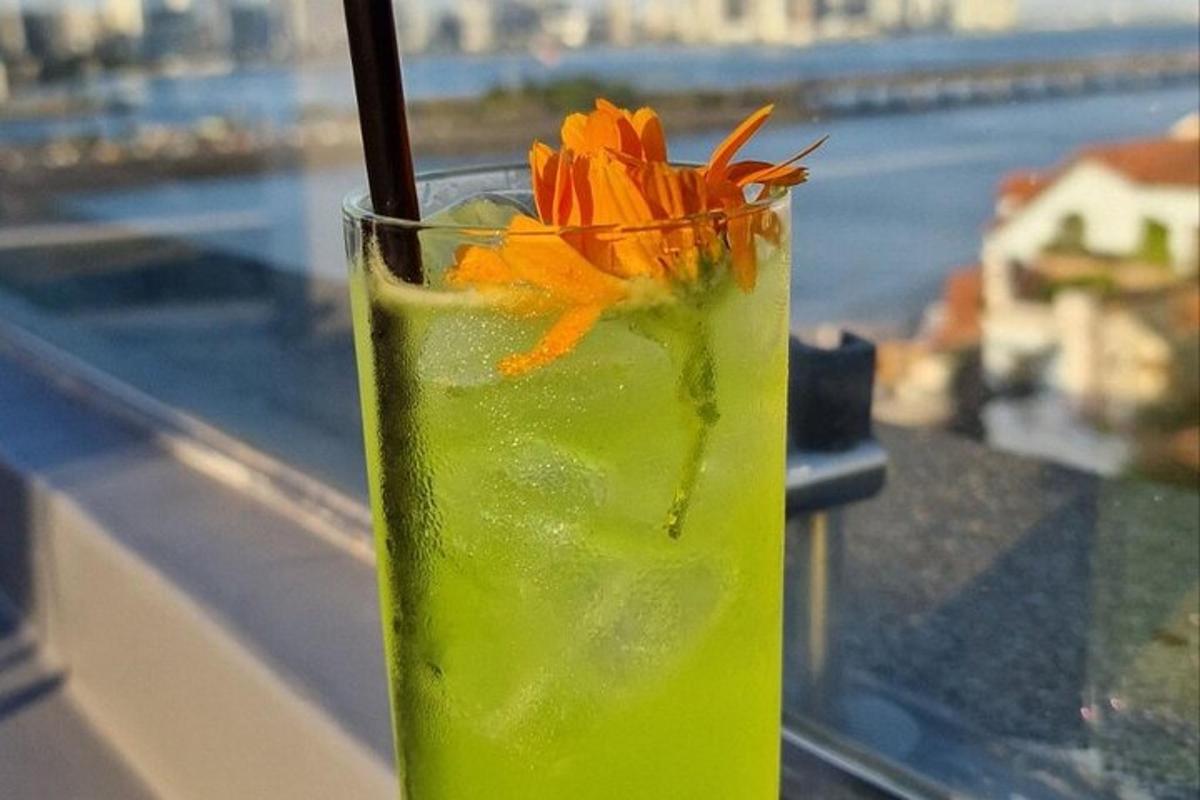 a drink with an orange flower on a ledge