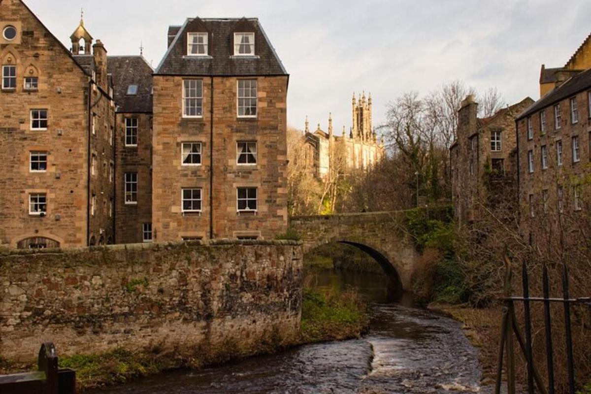 an old bridge over a river in a city