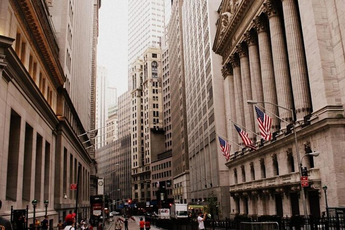 a city street with tall buildings with american flags