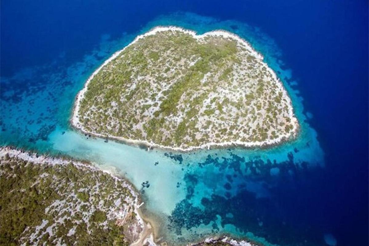an island in the ocean next to the water