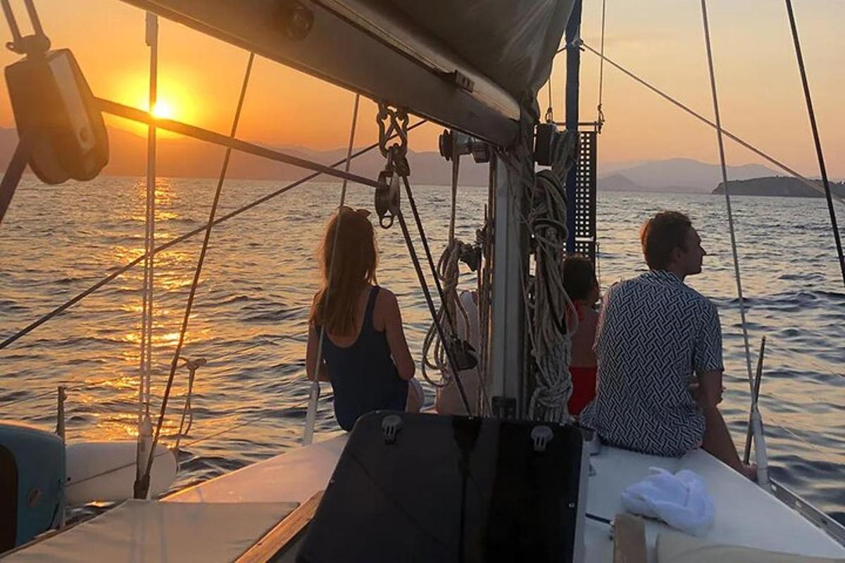 a man and a woman on a boat at sunset