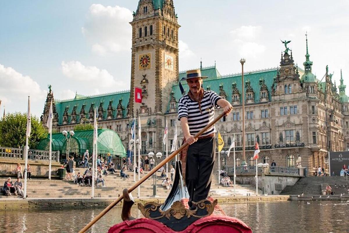 a man paddling an elephant in the water in front of a building