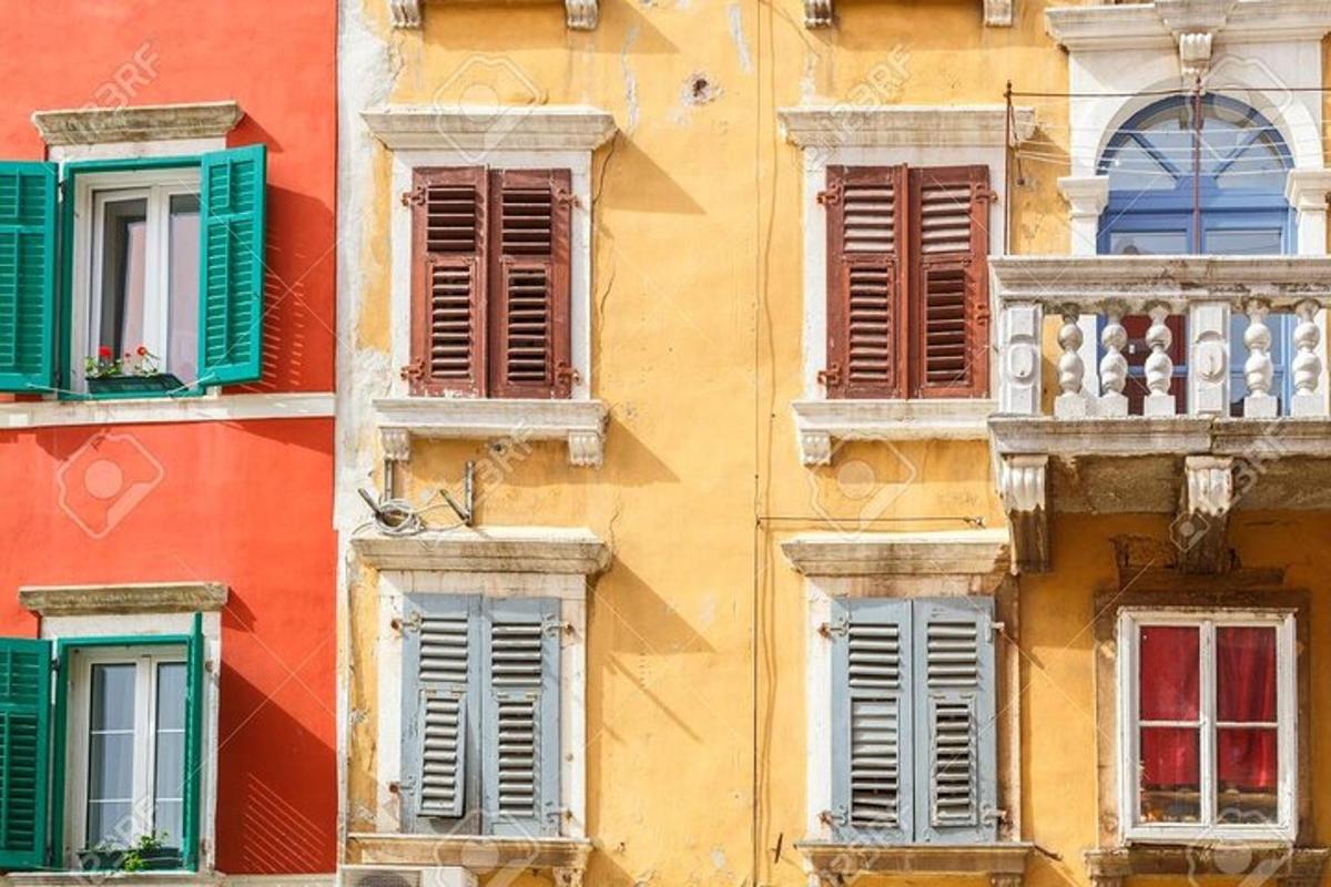 a facade of an old building with colorful windows