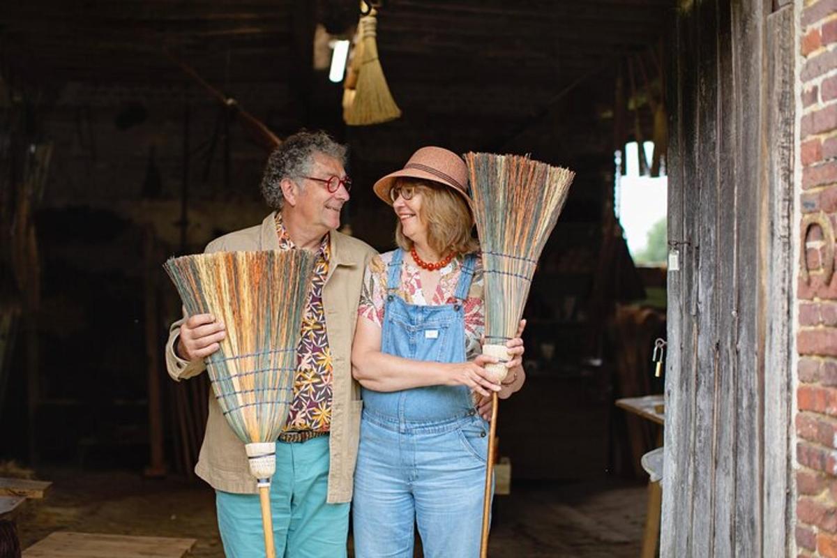 a man and a woman holding large fans